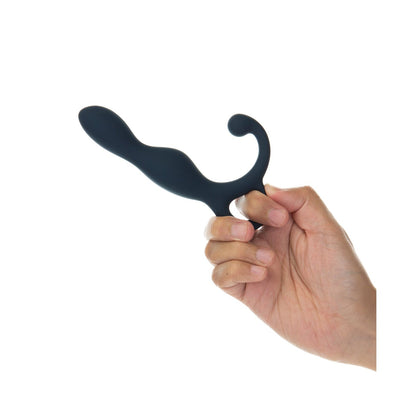 A hand holds the Lux Active LX1 Silicone Anal Trainer by LUX against a white background. This black massager features a smooth, rounded design with two distinct curves for ergonomic use and optimal perineum stimulation.