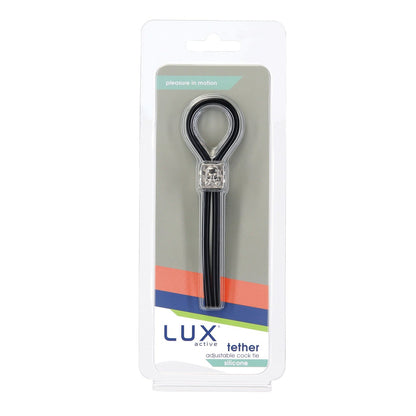 Image of a product labeled Lux Active Tether Adjustable Cock Tie by Adams Toy Box. This elegant tie, crafted from body-safe silicone, includes an adjustable loop for personal use. The packaging is transparent with a white background and has a multicolored stripe at the bottom to enhance performance appeal.