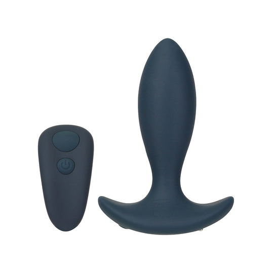The Lux Active Throb Anal Vibrating Massager by LUX, a dark silicone plug with a curved flared base, is displayed alongside a sleek wireless remote control with a power button on a pristine white background.