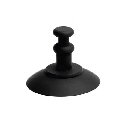 The MOD Suction Cup by MOD is a black, hand-shaped coffee tamper with a round, flat base and an ergonomic handle for easy grip. It offers hands-free functionality and adds a playful touch with its innovative design.