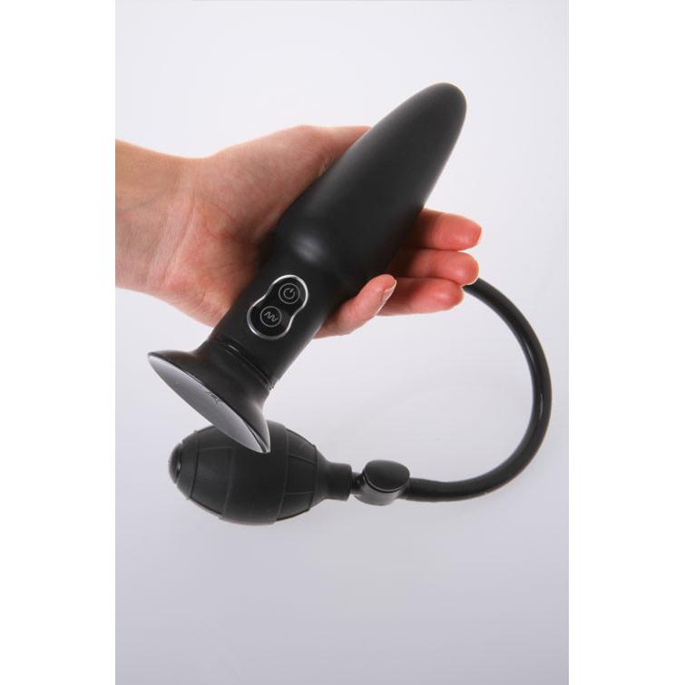 A hand holds the Malesation Inflatable Butt Plug w/ Vibration, a sleek black silicone design with an attached pump. It features control buttons and a tube for adjustable vibrations, offering personalized pleasure against a plain white background that highlights its modern functionality.