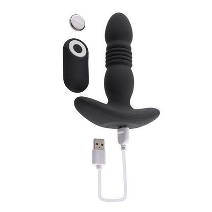 The Playboy Trust The Thrust Butt Plug - 2 AM by Playboy is a black silicone vibrating plug with ribbed texture, a wireless remote control, and a USB charging cable. This thrusting toy features an ergonomic design and detachable magnetic cap for an enhanced sensual experience.