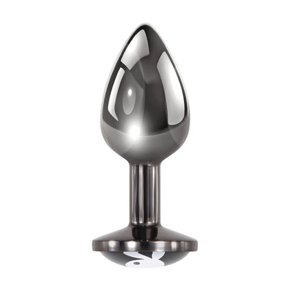 The Playboy Tux Butt Plug by Playboy is a sleek, glossy teardrop-shaped object with a wide circular base made from body-safe aluminum alloy, standing upright against a white background, perfect for adding elegance to your collection.
