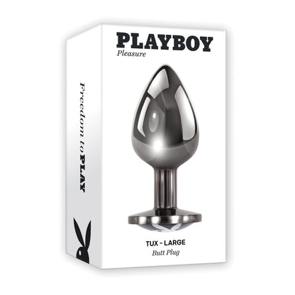 The image displays the packaging for Playboy Tux Butt Plug, intended for anal play. The box is white with a sleek black and silver plug image made of body-safe aluminum alloy on the front, and it features the iconic Playboy logo on the side.