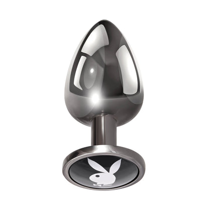 The Playboy Tux Butt Plug by Playboy is a sleek, modern design crafted from body-safe aluminum alloy. It features a metallic, cone-shaped reflective surface with a flat base adorned with the white silhouette of a rabbit head and ears.