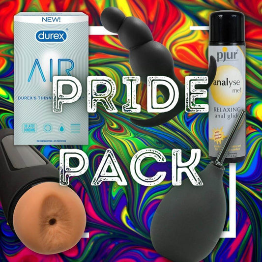 The PRIDE Essentials Pack from Adams Toy Box features Durex Air Condoms, a black anal toy, Pjur relaxing silicone lubricant, a flesh-colored toy, and a sleek black bulb set against a vibrant rainbow swirl.