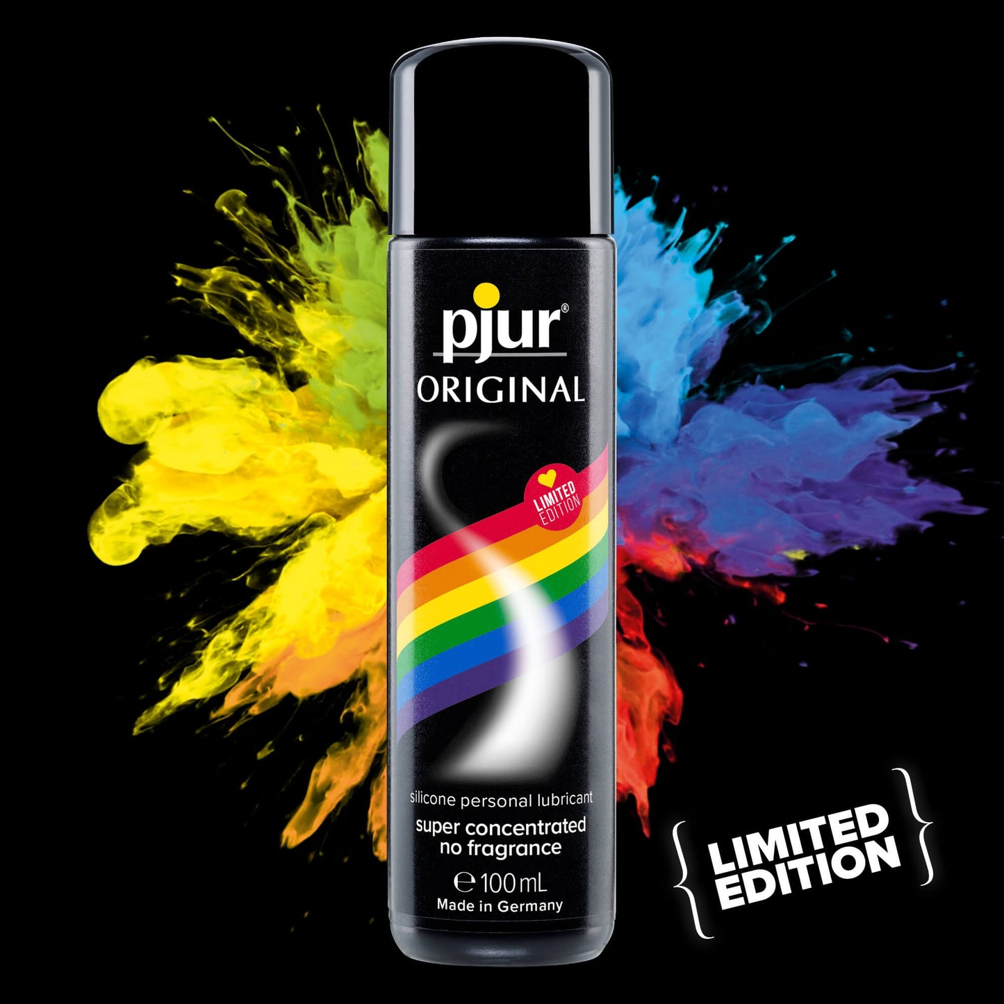 A Pjur Original Rainbow Edition Silicone Personal Lubricant bottle is shown with a black base and rainbow stripe label, stating super concentrated, no fragrance. Colorful paint splashes in the background celebrate its LGBTQ+ superhero pride.
