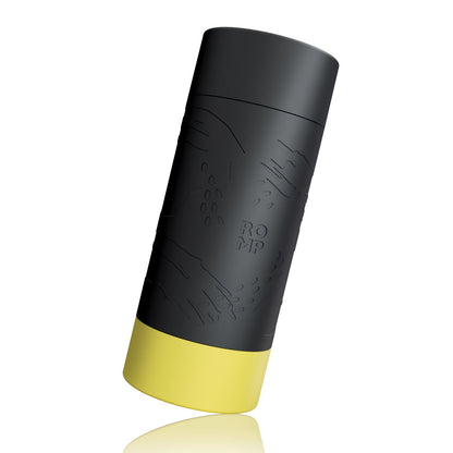 The ROMP Dash Stroker, featuring a black cylindrical design with a yellow base and embossed patterns along with the word Romp, is showcased against a white background. Made from body-safe silicone, it serves as a skin-soft stroker, providing natural suction for an enhanced experience.