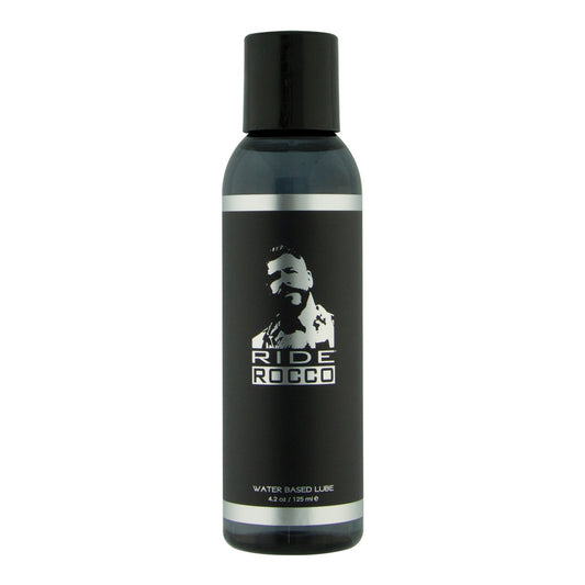 The 4 oz black bottle of Ride Rocco Water Based Lube features a silhouetted figure on the label, contains a long-lasting formula enriched with natural seaweed extracts, and comes with a sleek black cap.