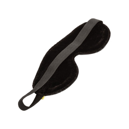 The Boundless Blackout Eye Mask by California Exotic Novelties, featuring a sleek, velvety texture and elastic strap, is shown on a plain white background to provide complete sensory deprivation for restful sleep.
