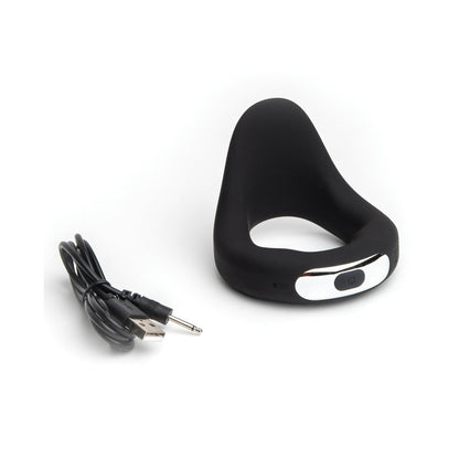 The Sport Fucker Motovibe Apex 48 mm, made of medical-grade silicone, showcases a black ring design with a metallic button. Its presented with a USB charging cable against a white background.