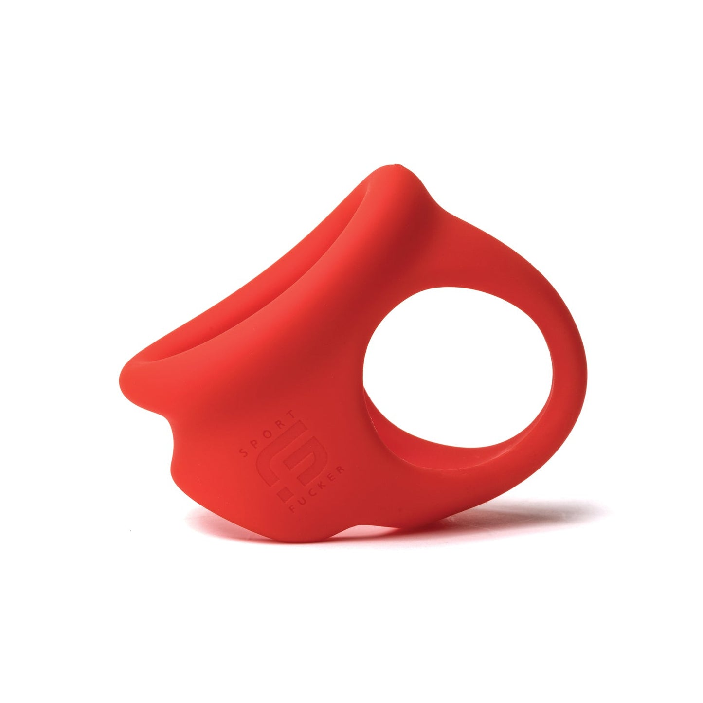 The Sport Fucker Cock Chute, a red silicone cock ring by Sport Fucker, features an ergonomic design with an open side and textured surface. Embossed branding adds style, while its sleek presentation against a white background enhances its appeal.