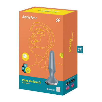 Orange box labeled Satisfyer Plug-ilicious 2 from Satisfyer, displays a minimalist face outline and product image. This app-controlled butt plug features an intuitive interface and waterproof design for enhanced pleasure.