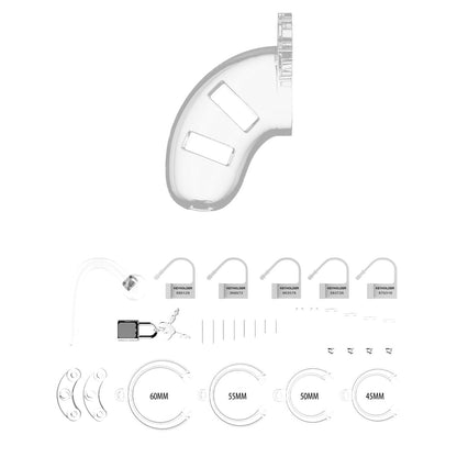 The Shots Man Cage Chastity 3.5 Cock Cage with Plug Model 10 by Adams Toy Box is a transparent cage ideal for BDSM play, featuring multiple rings, padlocks, keys, and spacers elegantly displayed below.