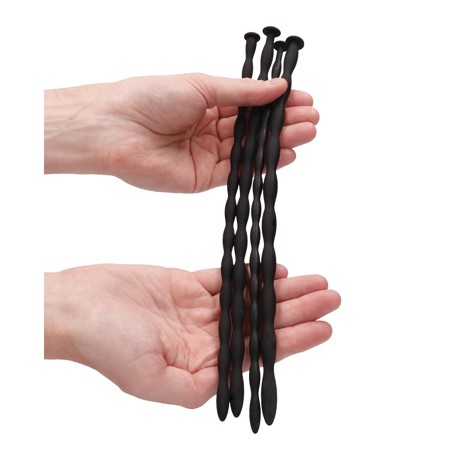 Two hands hold the Adams Toy Box Shots Ouch Advanced Urethral Sounding Silicone Spiral Plug Set, featuring three flexible black wavy rods with rounded ends against a plain white background.