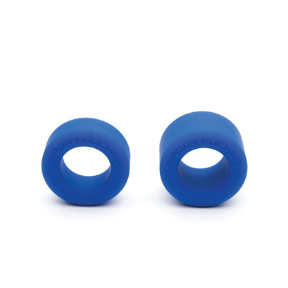 The Sport Fucker Nutt Job Ring set includes two blue silicone cock rings with SPORT FUCKER embossed on them, standing upright against a white background. Made from stretchy silicone, they also serve as ball stretchers for added versatility.