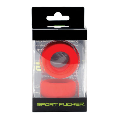 The image shows a retail package of the Sport Fucker Nutt Job Ring, a red silicone ring. The packaging has clear plastic with a black cardboard top, designed for hanging display, and highlights the stretchy silicone material.