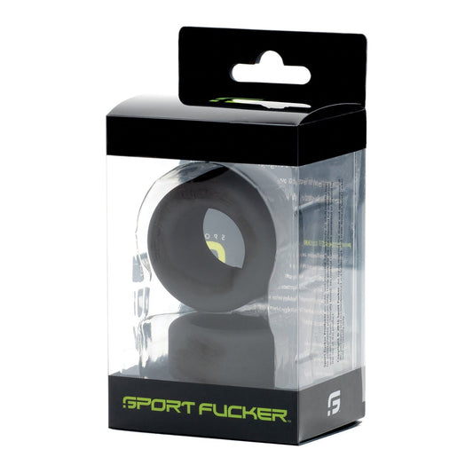 Inside the clear packaging, the Sport Fucker Nutt Job Ring is showcased. This solid black silicone cock ring is prominently branded with Sport Fucker and its logo, displayed in an upright box that highlights its sleek design.
