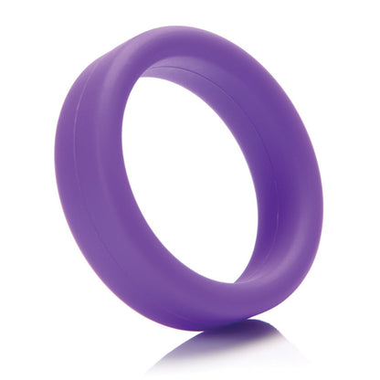 The Tantus 1.5 Supersoft C Ring, in purple silicone, stands upright on a white reflective surface. It appears smooth and evenly rounded, offering a comfortable experience with no visible markings or designs.