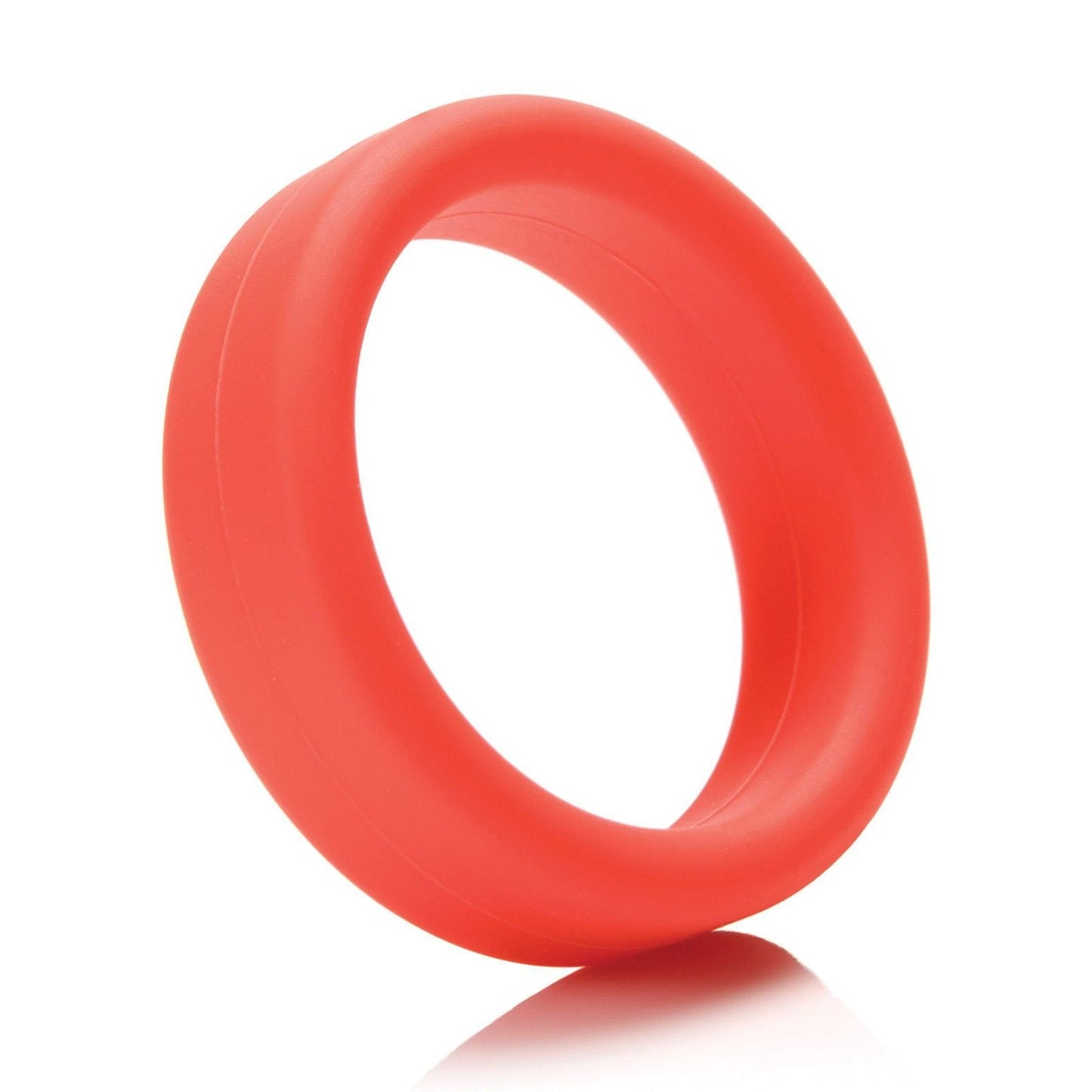The Tantus 1.5 Supersoft C Ring, a red silicone cock ring with a smooth surface, stands upright on a white background for a comfortable experience.