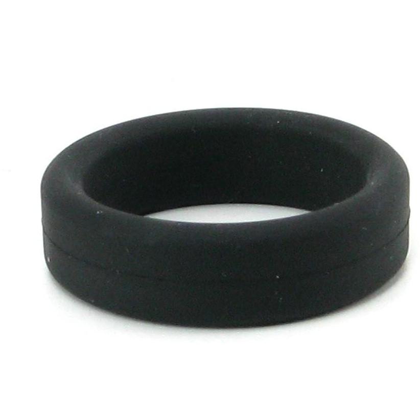 A Tantus 1.5 Supersoft C Ring lies on a white surface, creating a circular form. Made from silicone, this thick band shows slight texture and ensures comfort.