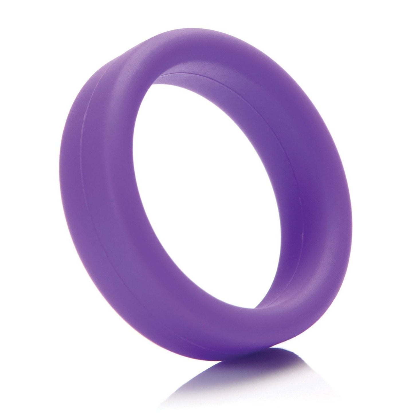 The Tantus 1.5 Supersoft C Ring, a purple, comfortable cock ring with a smooth surface, stands upright casting a small shadow on the white background.