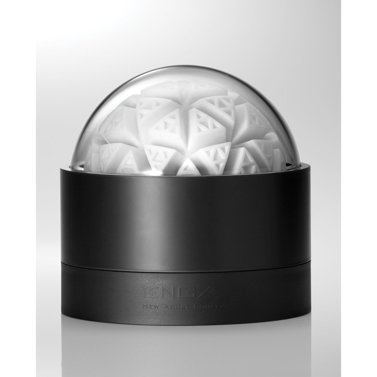 The Tenga GEO Glacier - White, by Tenga, features a futuristic black container with a stretchable material. It has a transparent dome lid that reveals an intricate geometric pattern of triangular shapes layered spherically on a white background, emphasizing its reusable design.