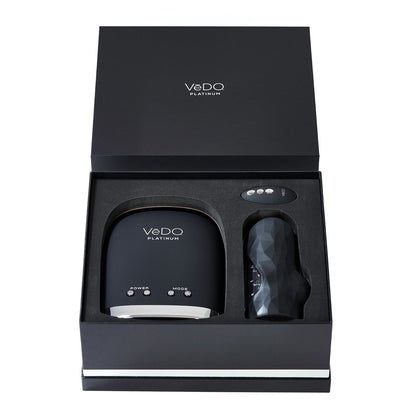 The VeDO Hummer 2.0 Masturbator box contains a sleek device, a textured cylindrical accessory, and a buttoned remote control, all neatly arranged in a custom mold for an experience similar to an automatic suction Hummer for ultimate satisfaction.
