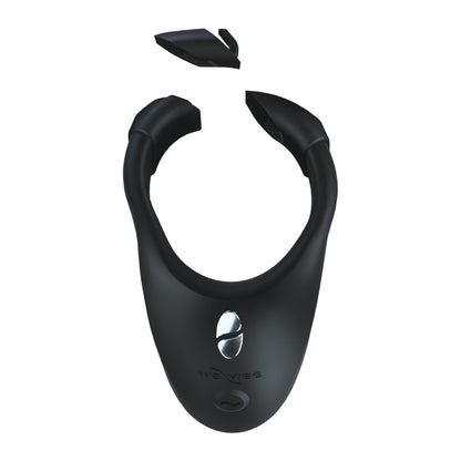 The We-Vibe Bond is a sleek black U-shaped electronic cock ring with a shiny silver button on the front and a detachable top piece. Made from body-safe silicone, it features the we-vibe brand elegantly printed on its surface.