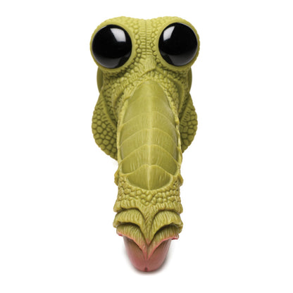 The Creature Cocks Swamp Monster Scaly Silicone Dildo features a close-up of its green, cartoonish dinosaur-like head with large black eyes and a textured snout. Made from phthalate-free silicone, it boasts intricate scales and pink-tipped nostrils against a white background.