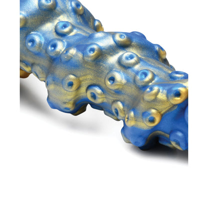 The Creature Cocks Lord Kraken Silicone Dildo features a textured surface with blue and gold metallic hues, resembling a deep-sea fantasy. Rounded protrusions evoke bubbles on its glossy finish, highlighting the intricate design akin to a premium silicone creation.