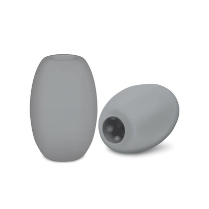 Two gray, cylindrical ZOLO Mini Bubble Stroker beads are shown. Crafted from a skin-mimicking material by Zolo, one stands upright while the other lies on its side, revealing a hollow interior like a bubble-textured tunnel.