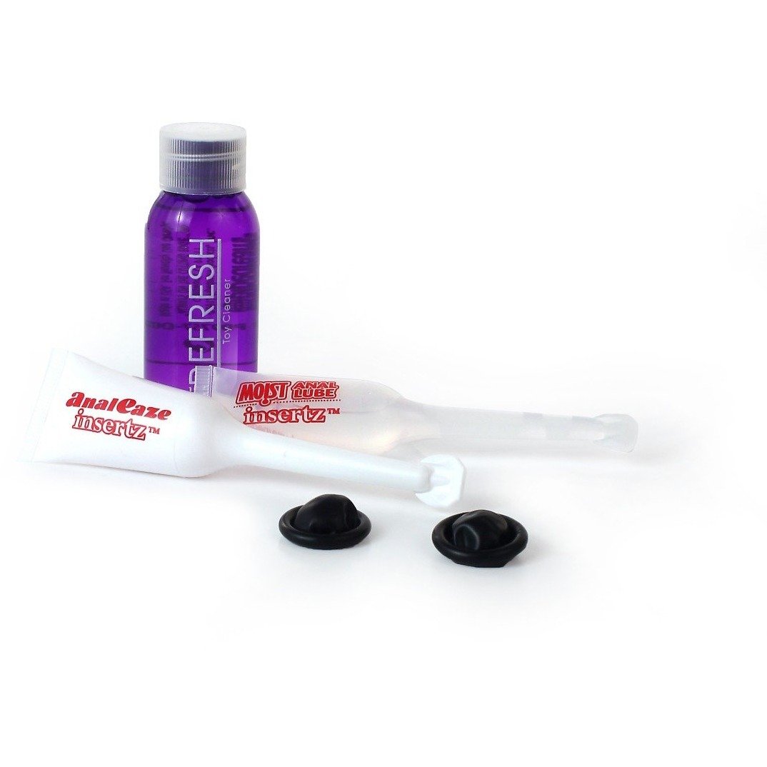 A purple Refresh bottle and white tubes labeled 4nalEase Insertz and Moist Insertz suggest playful exploration with your favorite anal toy. Two round black caps are in front, all arranged neatly on a pristine white surface alongside the Anal Fantasy Collection by Pipedream.