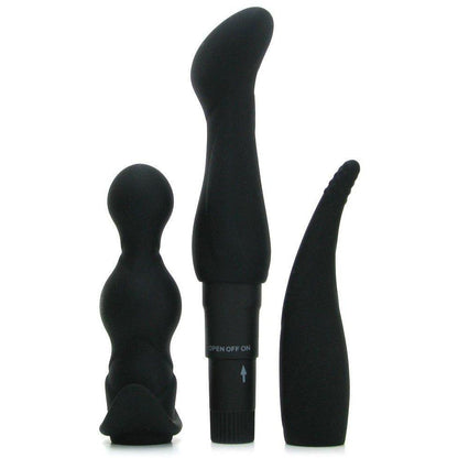 Three black silicone toys from the Pipedream Anal Fantasy Collection Anal Adventure Kit are displayed vertically against a white background. They vary in shape and size, with two bulbous-ended and one pointed with a curved tip. A battery compartment and control dial are seen on one toy.