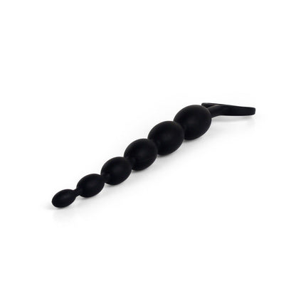 The Anal Fantasy First Time Fun Anal Beads by Pipedream features a series of progressively larger black silicone beads, ideal for beginners, connected with a loop handle for ease of use, providing a tapered effect.