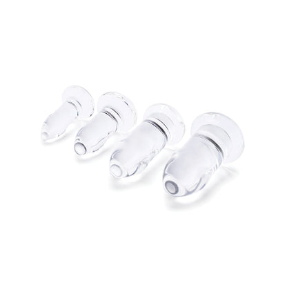 Four b-Vibe Glass Anal Dilators, crafted from body-safe materials and designed with flared edges for optimal comfort, are arranged in a row by size against a white background.