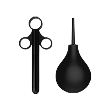 The b-vibe Anal Education Set features a black enema syringe with three-ring handles and a black bulb syringe, all against a white background. These tools by b-vibe support safe and informed anal play exploration.