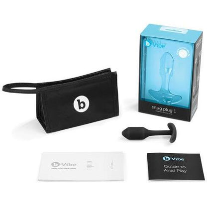 The image features the B-Vibe Snug Butt Plug 1 by b-vibe, made entirely from body-safe silicone. It includes a weighted plug, instruction booklets, and a branded black carry pouch, all in blue and white packaging.