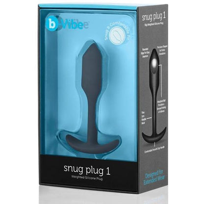 The image displays a blue box featuring the B-Vibe Snug Butt Plug 1 by b-vibe. The clear front shows the 100% silicone black plug inside, with text highlighting its body-safe design and comfort for extended wear.