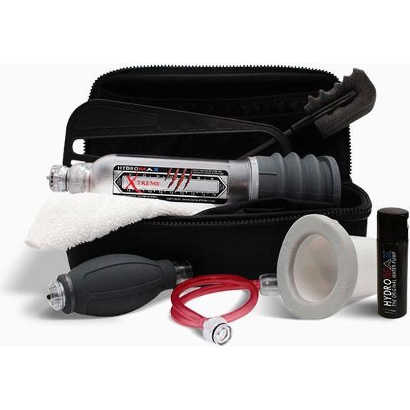 The Bathmate Hydromax Xtreme Series includes a black zippered case containing sexual health essentials: a clear cylindrical device with grips, a white ring, a small black pump with a red tube, a cleaning cloth, and a black bottle—ideal for Hydromax users.