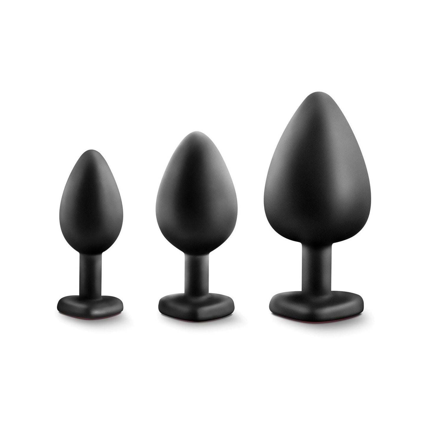 Three Blush Luxe Bling Plugs with Gems by Swiss Navy are lined up in a row against a white background. The plugs, crafted from body-safe black silicone, feature a tapered shape and flat base. Ideal for anal training enthusiasts looking for comfort and progression.