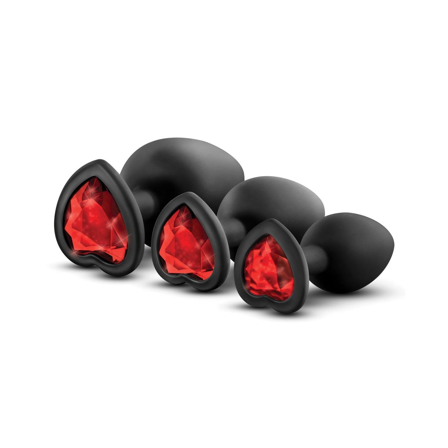The Blush Luxe Bling Plugs with Gems by Swiss Navy feature four black, heart-shaped pieces with red gem-like accents, arranged from small to large. Made of smooth material and body-safe silicone, they are artistically displayed against a plain background.