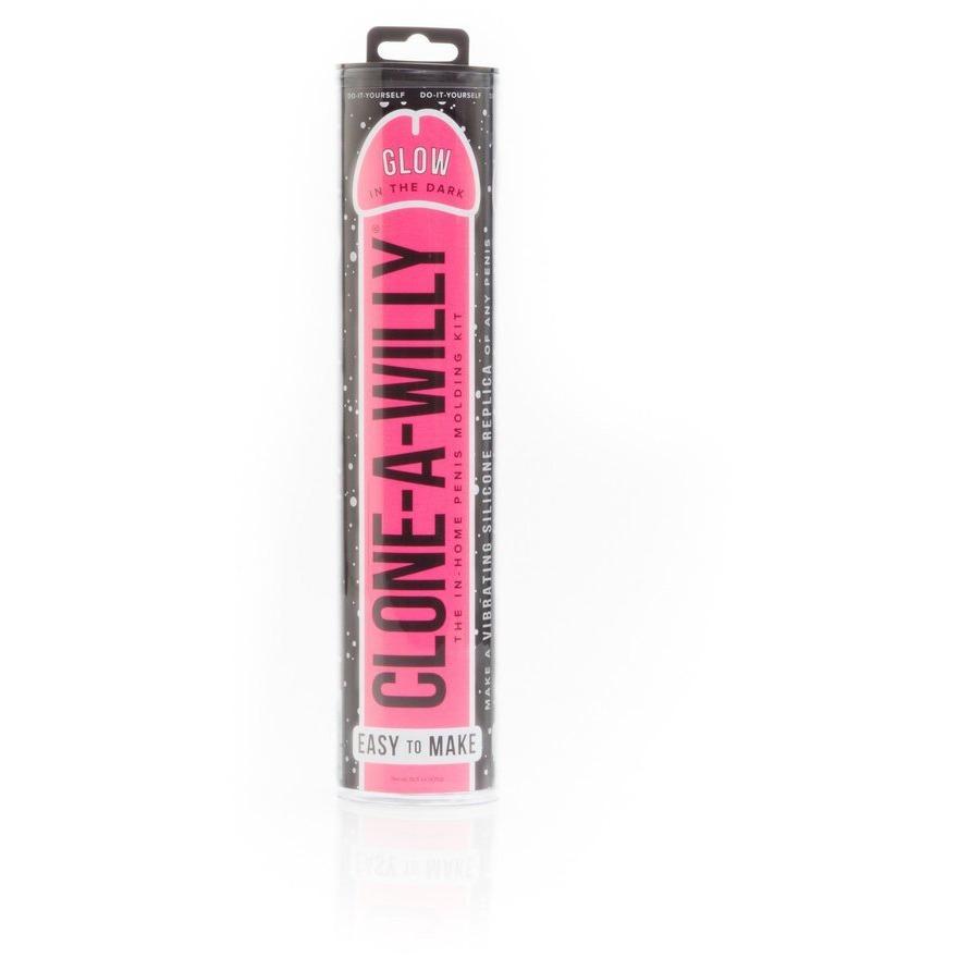 Photo of a clear cylindrical package labeled Clone-A-Willy Kit - Vibrating by Empire Labs in bold black letters on a pink backdrop. It promotes an easy-to-use, glow-in-the-dark vibrating penis replication kit made with body-safe silicone, showing the contents inside.