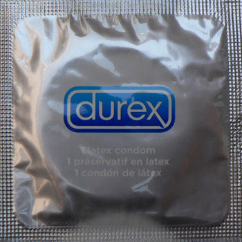 A silver foil packet labeled Durex Invisible Ulta Thin Condom from the brand Durex contains an ultra-thin latex condom.