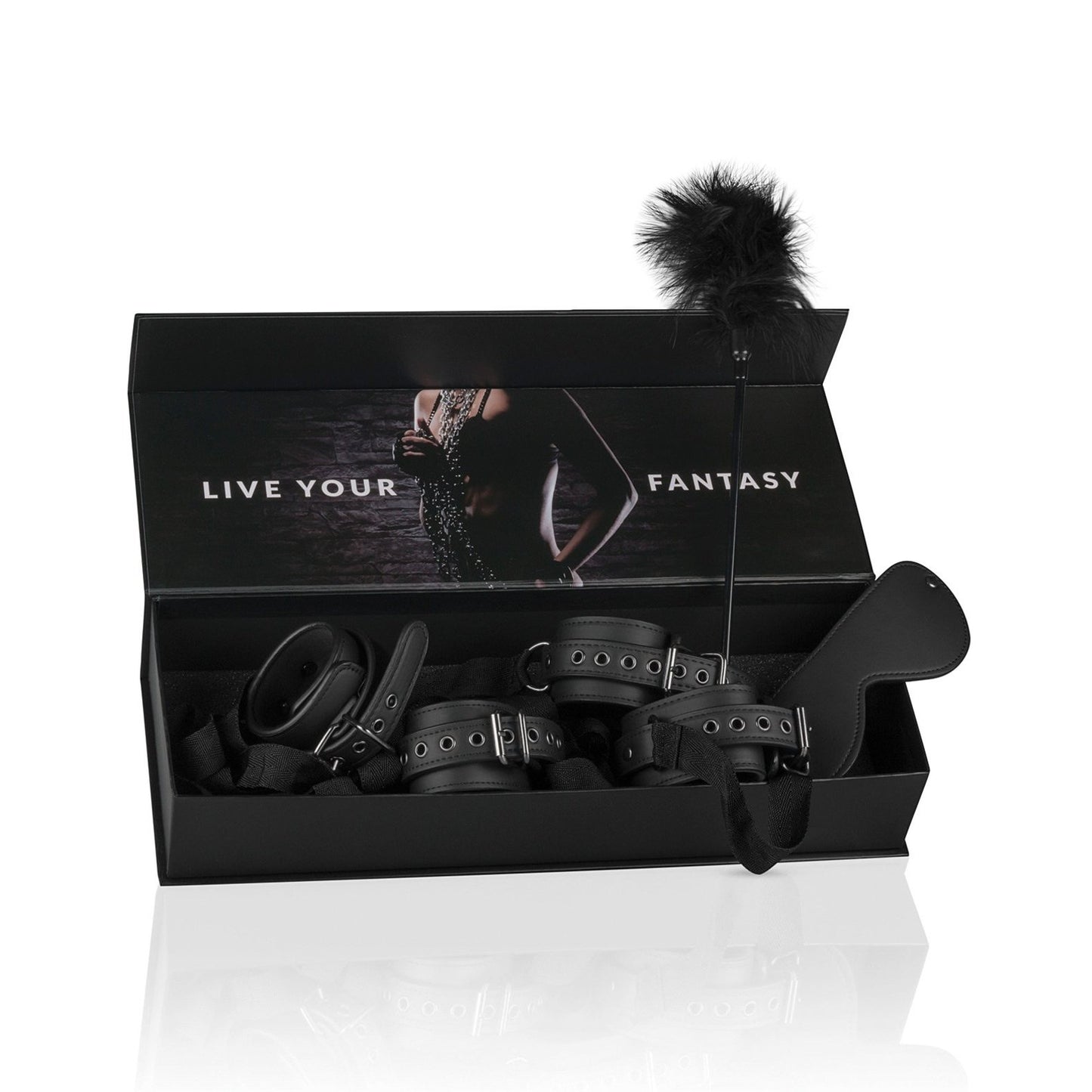 A black box reveals the Easy Toys Beginners 6 Piece Beginners bondage starter kit, featuring leather cuff restraints, a feather tickler, and a leather paddle. The lid shows a blurred image with Live Your Fantasy in bold white capital letters.