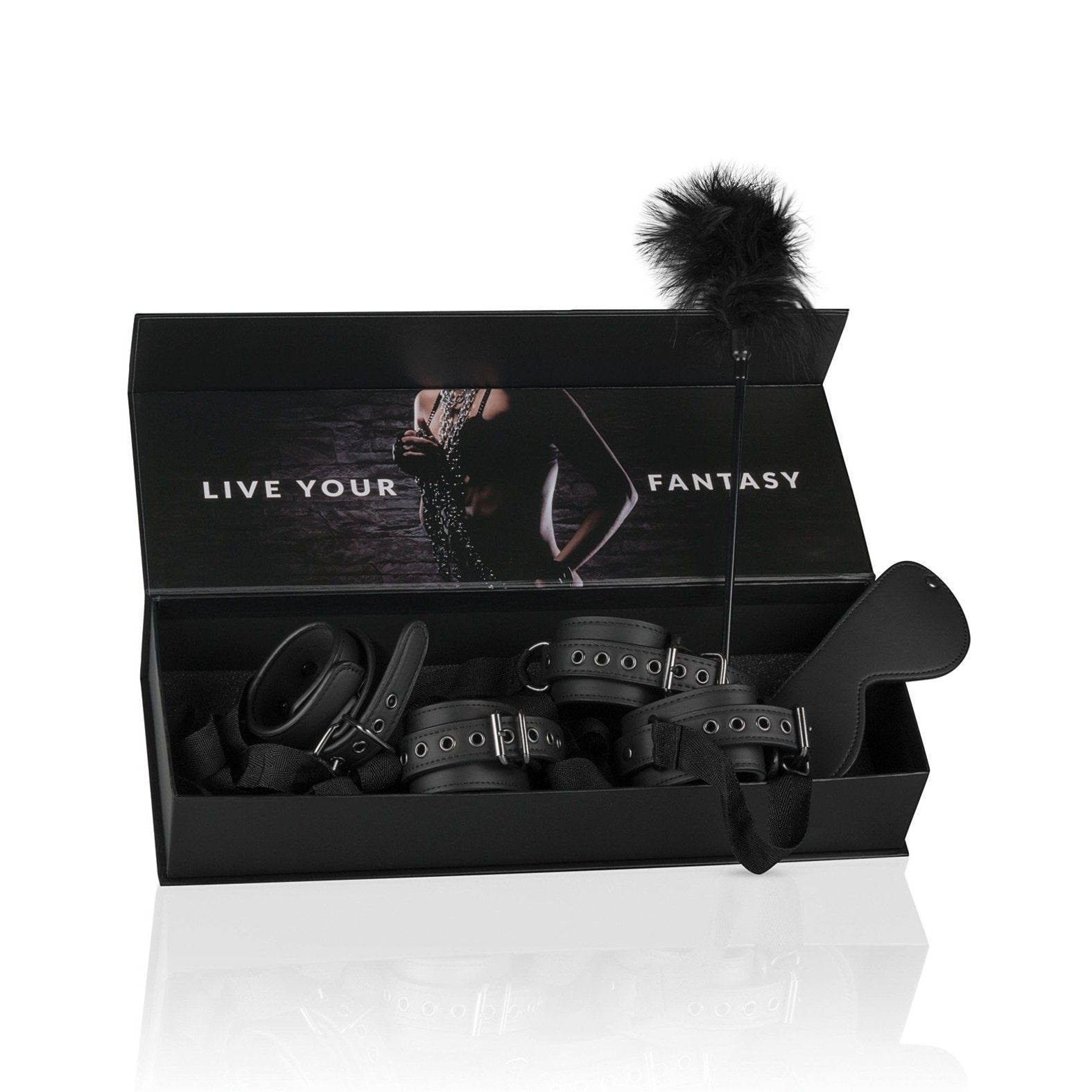 A black box reveals the Easy Toys Beginners 6 Piece Beginners bondage starter kit, featuring leather cuff restraints, a feather tickler, and a leather paddle. The lid shows a blurred image with Live Your Fantasy in bold white capital letters.