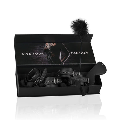 A black box reveals the Easy Toys Beginners 6 Piece Beginners bondage starter kit, featuring leather cuff restraints, a feather tickler, and a leather paddle. The lid shows a blurred image with Live Your Fantasy in bold white capital letters.