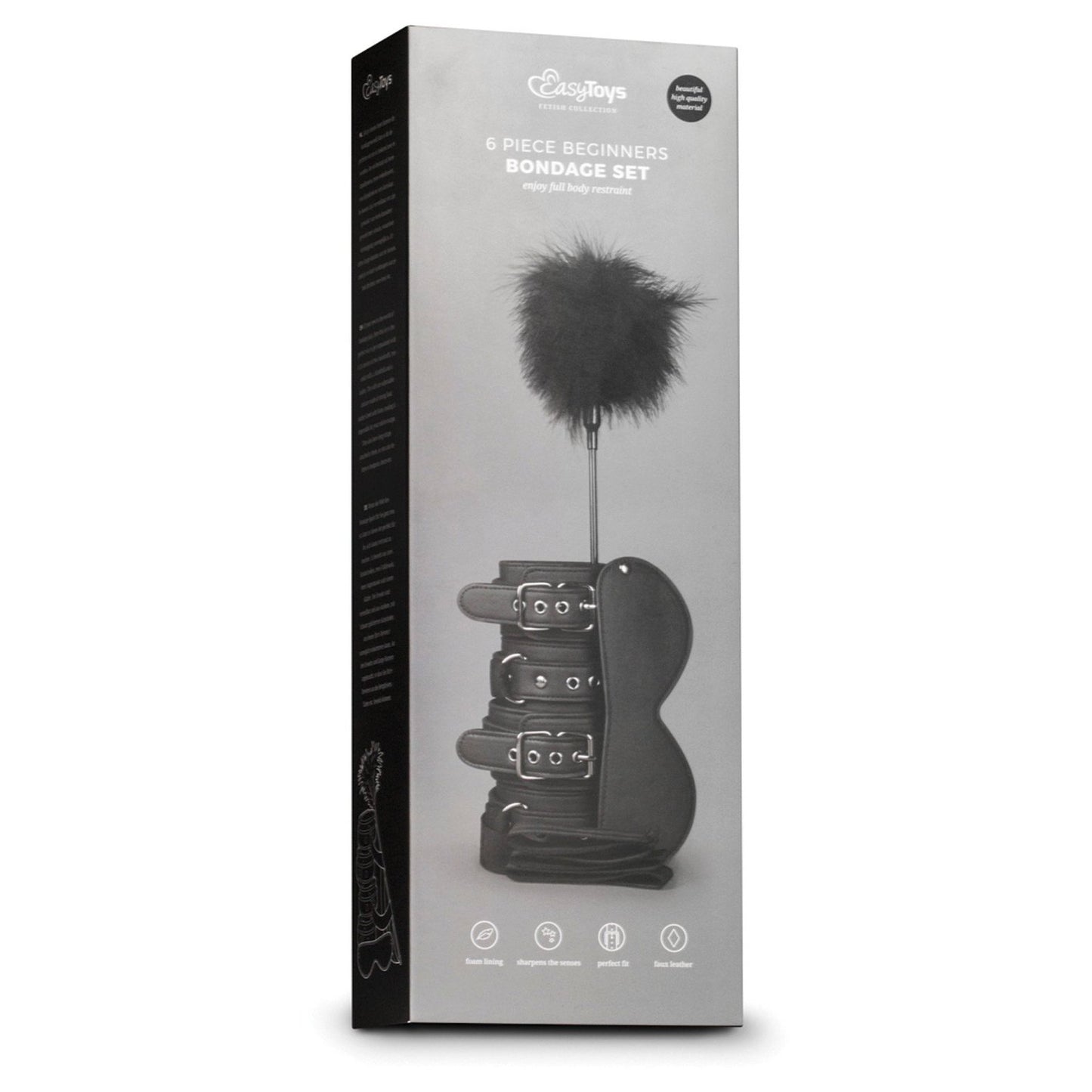 A box labeled Easy Toys Beginners 6 Piece Kit features images of black bondage items like cuff restraints and a feather tickler against a gray background, underscoring its beginner-friendly appeal.