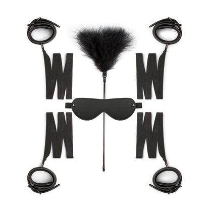 The Easy Toys Beginners 6 Piece set, featuring black cuff restraints, a feather tickler, an eyemask, and adjustable straps, is symmetrically arranged against a white background.