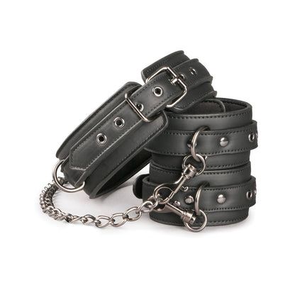 The Easy Toys Faux Leather Collar with Handcuffs features black faux leather, metal buckles, a connecting chain, silver grommets, and metal fastenings all set against a white background.